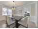 Elegant dining room with dark wood table and neutral chairs at 4851 Ridgewood Creek Nw Dr, Acworth, GA 30102