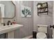 Powder room with gray patterned wallpaper and pedestal sink at 314 Sandalin Ln, Peachtree City, GA 30269