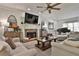 Spacious living room features a stone fireplace, hardwood floors, and ample seating at 314 Sandalin Ln, Peachtree City, GA 30269