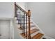 Stylish staircase featuring a wrought-iron railing and hardwood steps at 314 Sandalin Ln, Peachtree City, GA 30269