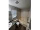 Main bathroom with beige tile, bathtub, and single vanity at 3246 Wallace Lake Rd, Douglasville, GA 30135