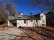 Side view of a light beige ranch house with mature trees at 3246 Wallace Lake Rd, Douglasville, GA 30135