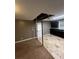 Open kitchen features dark cabinetry, tile floors, and black appliances at 3246 Wallace Lake Rd, Douglasville, GA 30135