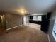 Open kitchen features dark cabinetry, tile floors and black appliances at 3246 Wallace Lake Rd, Douglasville, GA 30135