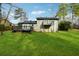 Expansive backyard featuring a lush green lawn, a wooden deck, and balcony for outdoor enjoyment at 5507 Flat Shoals Pkwy, Decatur, GA 30034