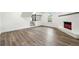 Unfurnished basement with white brick fireplace and hardwood floors at 5507 Flat Shoals Pkwy, Decatur, GA 30034