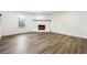 Unfurnished basement with a brick fireplace, new flooring, and natural light at 5507 Flat Shoals Pkwy, Decatur, GA 30034