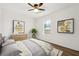 Bright bedroom featuring light-colored walls, modern decor, and a ceiling fan at 5507 Flat Shoals Pkwy, Decatur, GA 30034