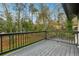 Inviting wooden deck with railings, offering scenic views of surrounding trees at 5507 Flat Shoals Pkwy, Decatur, GA 30034