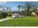 Picturesque two-story home with lush green lawn, gray siding, and freshly mulched flower beds at 5507 Flat Shoals Pkwy, Decatur, GA 30034