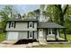 Inviting split-level home featuring a gray exterior, black shutters, and a well-manicured front yard with mulch at 5507 Flat Shoals Pkwy, Decatur, GA 30034