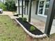 Close-up of the front porch landscaping with fresh black mulch and a gray stone border at 5507 Flat Shoals Pkwy, Decatur, GA 30034