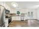 Modern kitchen featuring stainless appliances, white cabinets, and access to outdoor deck at 5507 Flat Shoals Pkwy, Decatur, GA 30034