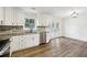 Contemporary kitchen boasts granite counters, stainless appliances, and bright white cabinetry at 5507 Flat Shoals Pkwy, Decatur, GA 30034