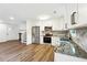 Bright kitchen features stainless appliances, granite counters, and modern white cabinets at 5507 Flat Shoals Pkwy, Decatur, GA 30034
