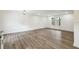 Open-concept living room with hardwood floors, clean white walls, and a large window overlooking the neighborhood at 5507 Flat Shoals Pkwy, Decatur, GA 30034