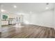 Bright living space with hardwood floors, white cabinets, stainless appliances, and access to outdoor patio at 5507 Flat Shoals Pkwy, Decatur, GA 30034