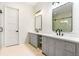 Double vanity bathroom with gray cabinets and black fixtures at 1240 Spalding Dr, Sandy Springs, GA 30350