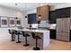 Modern kitchen with dark cabinetry, quartz countertops, and island seating at 1240 Spalding Dr, Sandy Springs, GA 30350