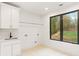 Laundry room with white cabinets and a large window at 1240 Spalding Dr, Sandy Springs, GA 30350