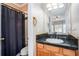 Functional bathroom featuring a shower with a curtain and a vanity with a stylish mirror at 1350 Eryn Cir, Suwanee, GA 30024