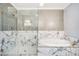 Modern bathroom with glass walk-in shower, and a soaking tub with tile surround at 1350 Eryn Cir, Suwanee, GA 30024