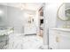 Luxurious bathroom with marble floors, a soaking tub and double sink vanity at 1350 Eryn Cir, Suwanee, GA 30024