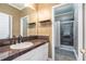 Inviting bathroom featuring a dark countertop vanity and a shower with glass doors at 1350 Eryn Cir, Suwanee, GA 30024