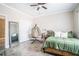 Comfortable bedroom with natural light, wood-look flooring, and stylish decor at 1350 Eryn Cir, Suwanee, GA 30024