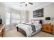 Light-filled bedroom with a large window, cozy decor, and carpet flooring at 1350 Eryn Cir, Suwanee, GA 30024