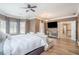Large primary bedroom with hardwood floors, ceiling fan, and a view into the hall at 1350 Eryn Cir, Suwanee, GA 30024