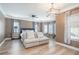 Spacious bedroom with hardwood floors, ceiling fan, and large windows for natural light at 1350 Eryn Cir, Suwanee, GA 30024