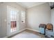 Bright bedroom featuring a door to the outside, neutral walls, and carpeted floor at 1350 Eryn Cir, Suwanee, GA 30024