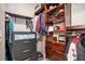 Organized walk-in closet with custom shelving and storage solutions for clothing and accessories at 1350 Eryn Cir, Suwanee, GA 30024