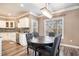 Bright dining room with a rustic table, chandelier lighting, and view of the backyard at 1350 Eryn Cir, Suwanee, GA 30024