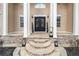 Elegant home entrance featuring a stone pathway and pillars with a decorative double door at 1350 Eryn Cir, Suwanee, GA 30024