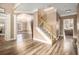 Spacious foyer with hardwood floors, chandelier, staircase, and views into the office and living room at 1350 Eryn Cir, Suwanee, GA 30024