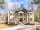 Stately home featuring a pillared front entry, symmetrical windows, and a circular driveway at 1350 Eryn Cir, Suwanee, GA 30024