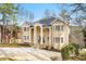 Beautiful home with striking curb appeal, a columned entrance, and a well-maintained front yard at 1350 Eryn Cir, Suwanee, GA 30024