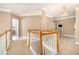 Bright hallway with a carpeted floor and white railings, providing access to multiple rooms at 1350 Eryn Cir, Suwanee, GA 30024
