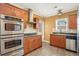 Well-lit kitchen with stainless steel appliances, wood cabinets, and granite countertops at 1350 Eryn Cir, Suwanee, GA 30024