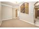 Open living space with beige walls, white trim, and carpeted and tiled floors at 1350 Eryn Cir, Suwanee, GA 30024