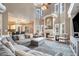 Spacious living room featuring a fireplace, large windows, and open layout to the kitchen at 1350 Eryn Cir, Suwanee, GA 30024