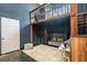 Stylish sitting area with a loft above featuring dark blue walls and hardwood accents at 1350 Eryn Cir, Suwanee, GA 30024