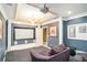 Home theater room features projector, tiered seating, and dark walls at 1350 Eryn Cir, Suwanee, GA 30024