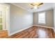 Empty bedroom featuring wood floors, window, neutral paint, closet, and door to en suite at 884 Custer Se Ave, Atlanta, GA 30316