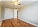 An empty bedroom with hardwood floors, a ceiling fan, fresh paint, and a closet at 884 Custer Se Ave, Atlanta, GA 30316