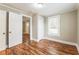 Bright bedroom featuring fresh paint, wood floors, a closet, and natural light from the window at 884 Custer Se Ave, Atlanta, GA 30316