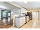 Open kitchen with stainless appliances and white cabinets, seamlessly flowing to the living area at 884 Custer Se Ave, Atlanta, GA 30316