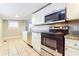 A kitchen featuring white cabinets, granite counters, stainless steel appliances, and tile floors at 884 Custer Se Ave, Atlanta, GA 30316